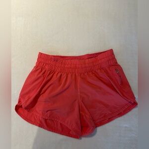 Lululemon- women’s size 10 - track that 3.5 inch short- color: coral
